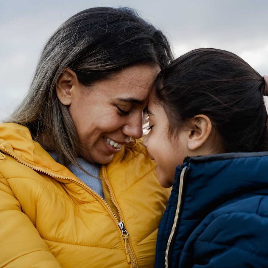 Hispanic mother and daughter embracing